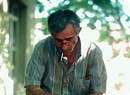 Fisherman repairing fish net